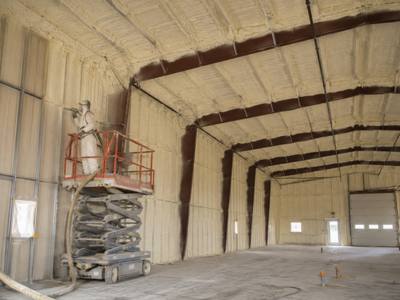 Commercial building sprayed in sections from a lift