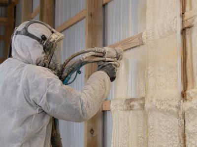 Foam being applied between wall girts