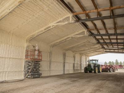 Machine storage barn sprayed from a scissor lift
